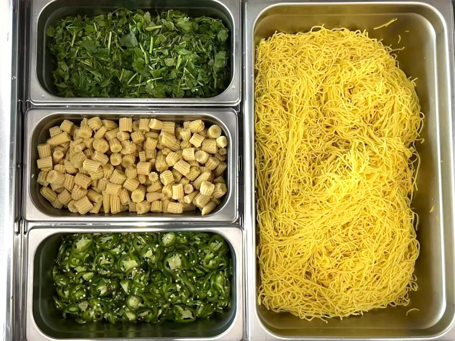 Fresh cilantro, baby corn, jalapeños and noodles prep station at Otasty Mongolian BBQ Restaurant in Citrus Heights